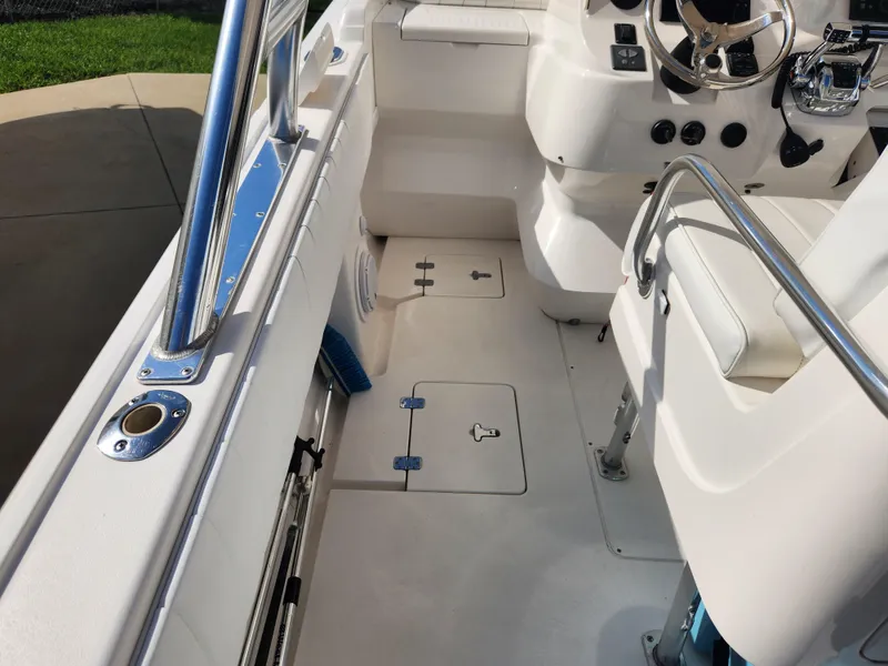 Slide: The Image of 2008 Intrepid 323 Cuddy boat interior with steering wheel and seating area. - 21