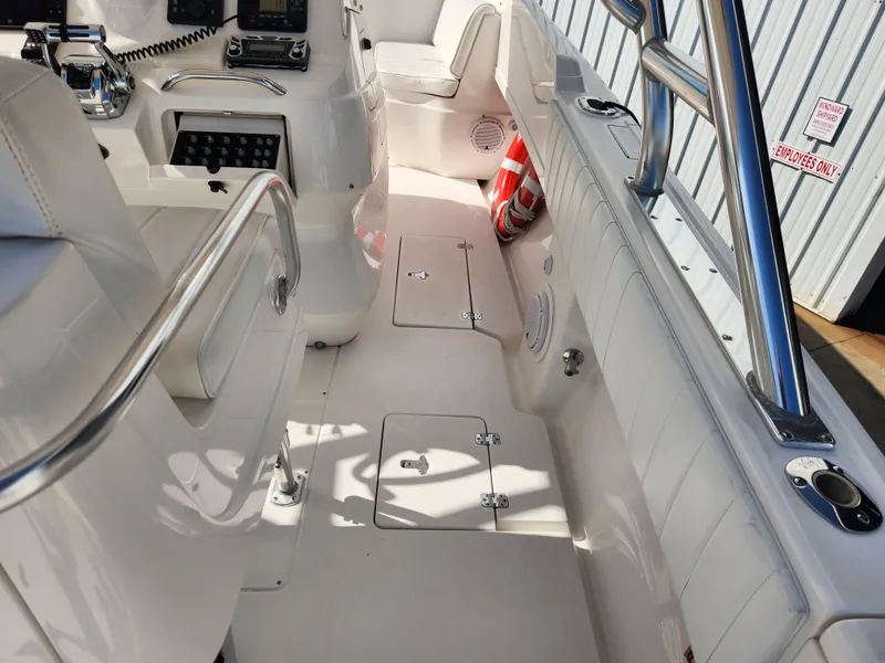 Slide: The Image of 2008 Intrepid 323 Cuddy interior with white seating and control panel. - 22