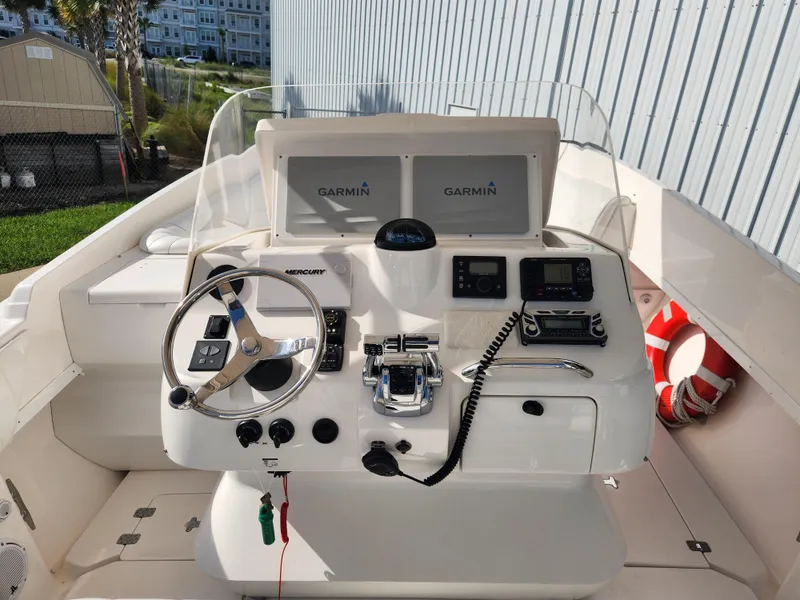 Slide: The Image of 2008 Intrepid 323 Cuddy boat helm with Garmin displays and Mercury controls. - 24