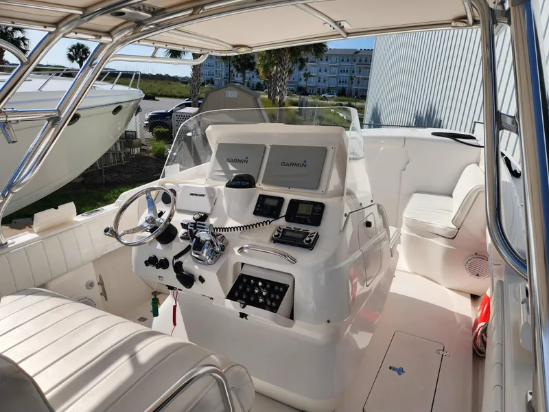 Slide: The Image of 2008 Intrepid 323 Cuddy boat cockpit with Garmin navigation system and seating. - 25