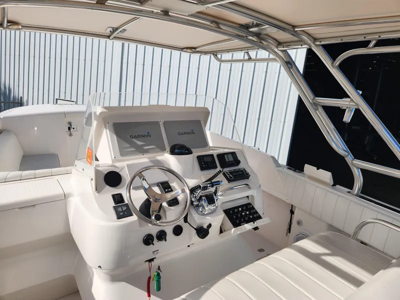 Slide: The Image of 2008 Intrepid 323 Cuddy boat cockpit with Garmin navigation system and sleek steering wheel. - 26
