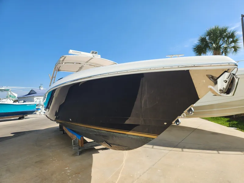 Slide: The Image of 2008 Intrepid 323 Cuddy boat on display, featuring sleek design and Garmin equipment. - 3