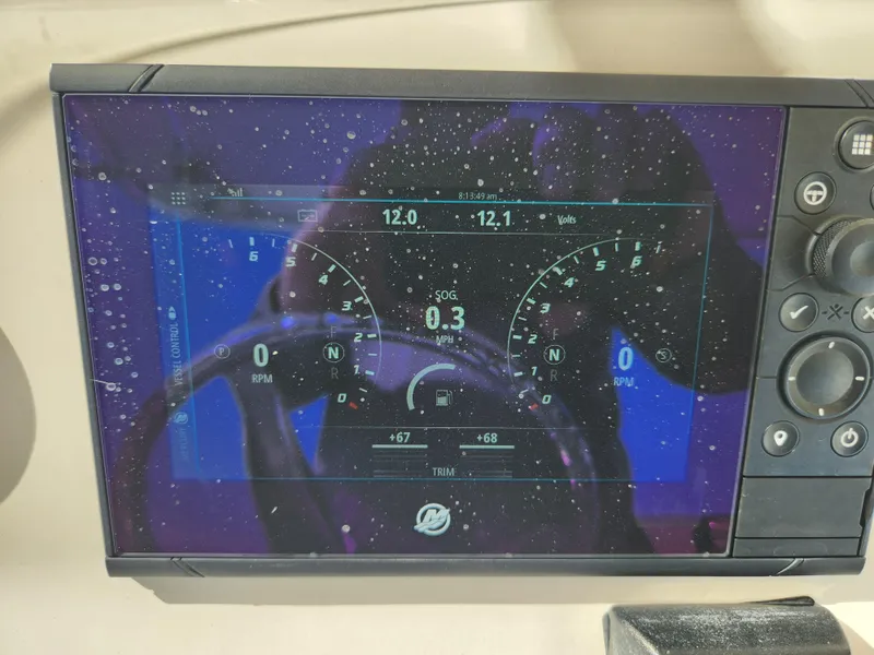 Slide: The Image of Digital dashboard of a 2008 Intrepid 323 Cuddy boat displaying RPM and voltage. - 30