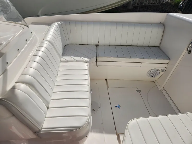 Slide: The Image of 2008 Intrepid 323 Cuddy boat interior with white cushioned seating. - 38