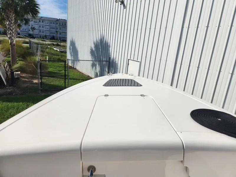 Slide: The Image of 2008 Intrepid 323 Cuddy boat docked beside a metal building. - 42