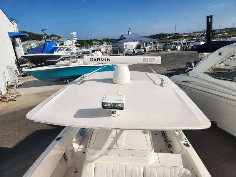 Slide: The Image of 2008 Intrepid 323 Cuddy boat with Garmin radar, docked at a marina. - 46