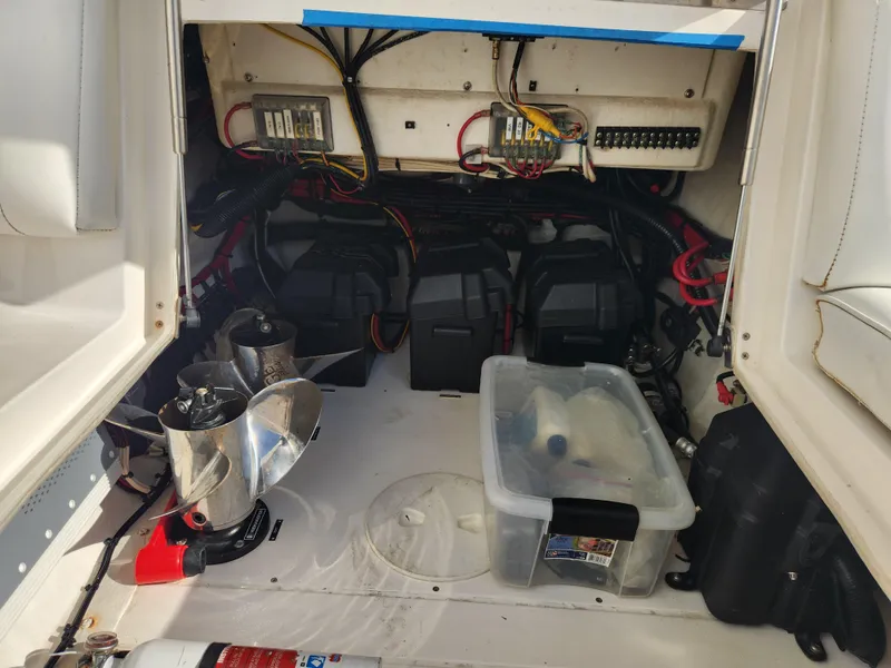 Slide: The Image of 2008 Intrepid 323 Cuddy engine compartment with batteries, wiring, and propellers. - 47