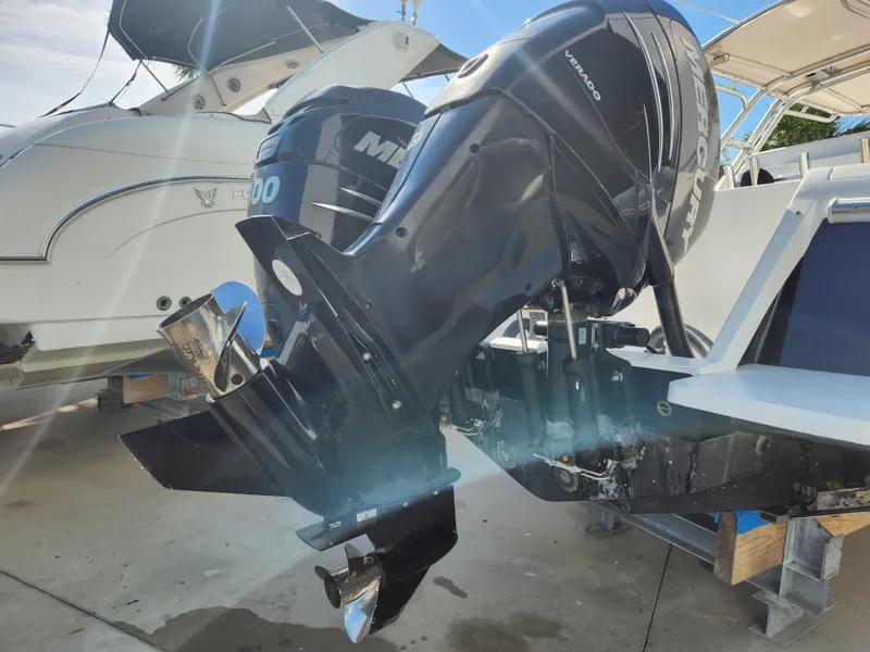 Slide: The Image of 2008 Intrepid 323 Cuddy with Mercury Verado outboard engines, docked in a marina. - 8