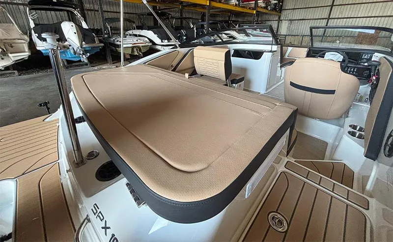 Slide: The Image of 2025 Sea Ray SPX 190 Outboard boat interior with tan seating and modern design. - 10