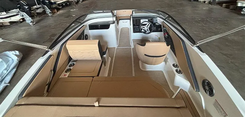 Slide: The Image of 2025 Sea Ray SPX 190 Outboard interior with tan seating and modern dashboard. - 11