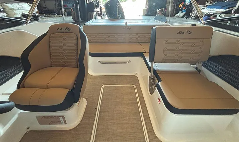 Slide: The Image of 2025 Sea Ray SPX 190 Outboard interior with tan seating and modern design. - 12