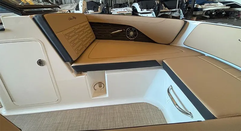 Slide: The Image of 2025 Sea Ray SPX 190 Outboard interior with tan seating and modern design. - 16