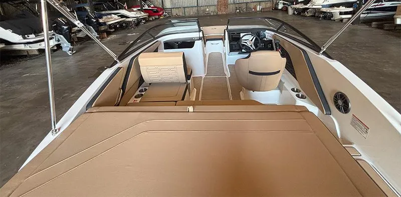 Slide: The Image of 2025 Sea Ray SPX 190 Outboard boat interior with beige seating and modern dashboard. - 9