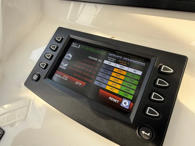 Slide: The Image of Display screen on 2018 Intrepid 375 Open showing engine service reminders. - 12