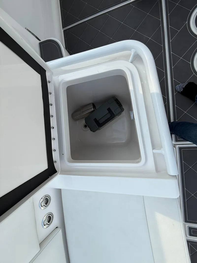 Slide: The Image of Storage compartment on a 2018 Intrepid 375 Open boat, featuring a clean interior. - 16