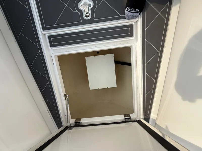 Slide: The Image of Open hatch on 2018 Intrepid 375 Open boat, showing interior compartment. - 18