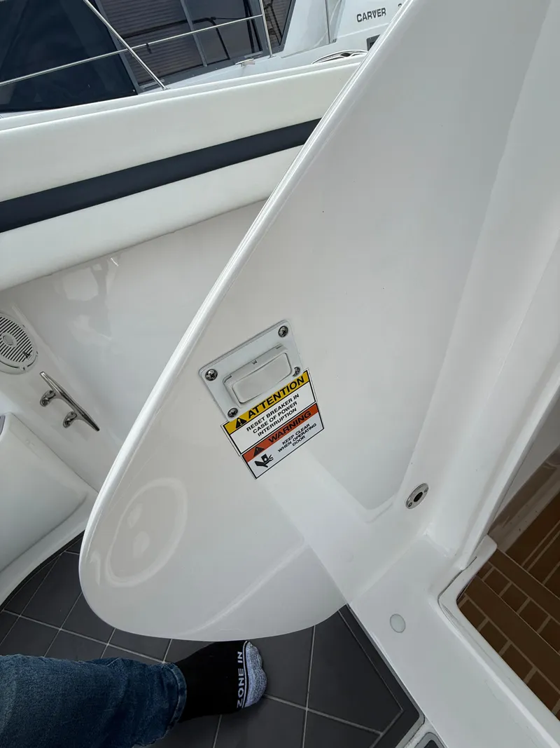 Slide: The Image of 2018 Intrepid 375 Open boat interior with caution label on white panel. - 19