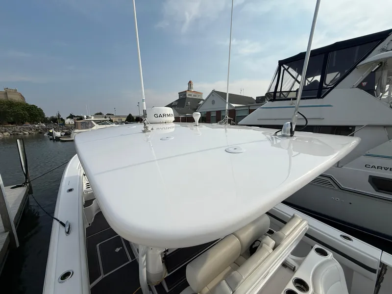 Slide: The Image of 2018 Intrepid 375 Open boat docked, featuring sleek design and Garmin equipment. - 22