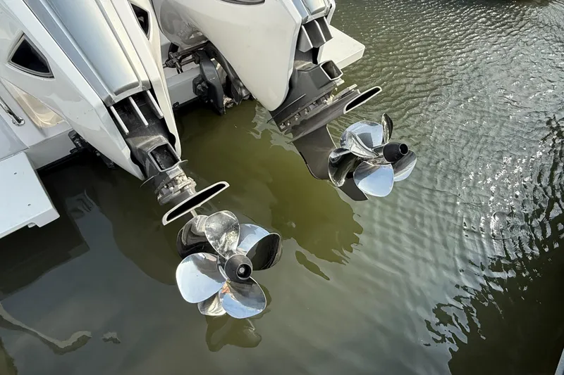 Slide: The Image of Twin outboard motors on a 2018 Intrepid 375 Open boat, reflecting in water. - 24