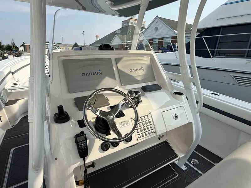 Slide: The Image of 2018 Intrepid 375 Open boat helm with Garmin displays and steering wheel. - 5
