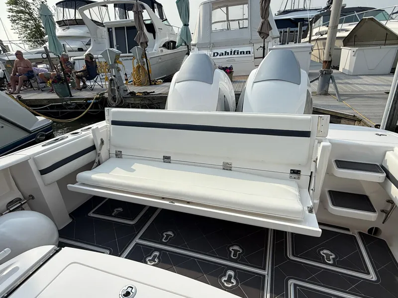 Slide: The Image of 2018 Intrepid 375 Open boat with foldable seating at marina dock. - 6