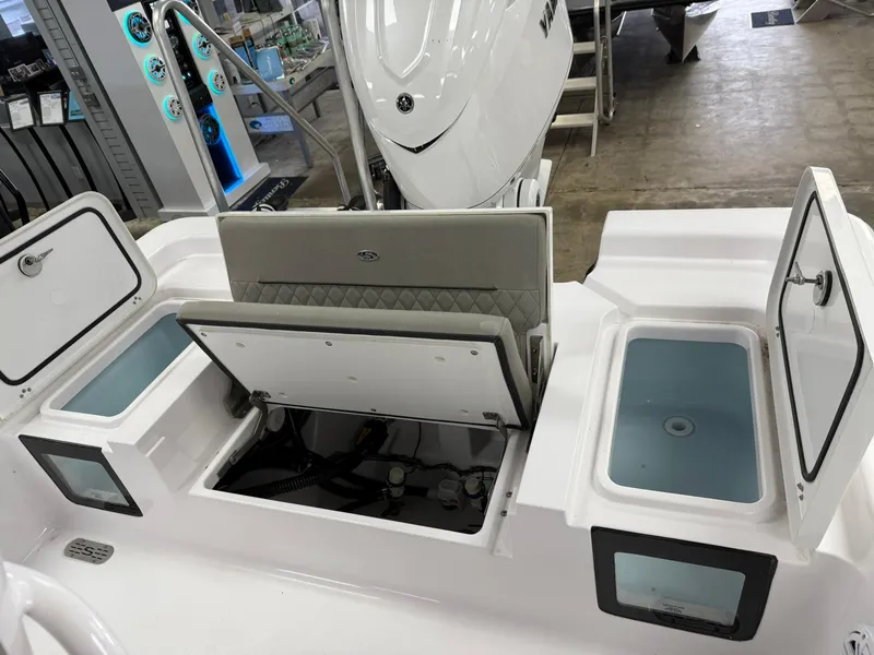 Slide: The Image of 2025 Sportsman Masters 247OE Bay Boat interior with open storage compartments. - 6