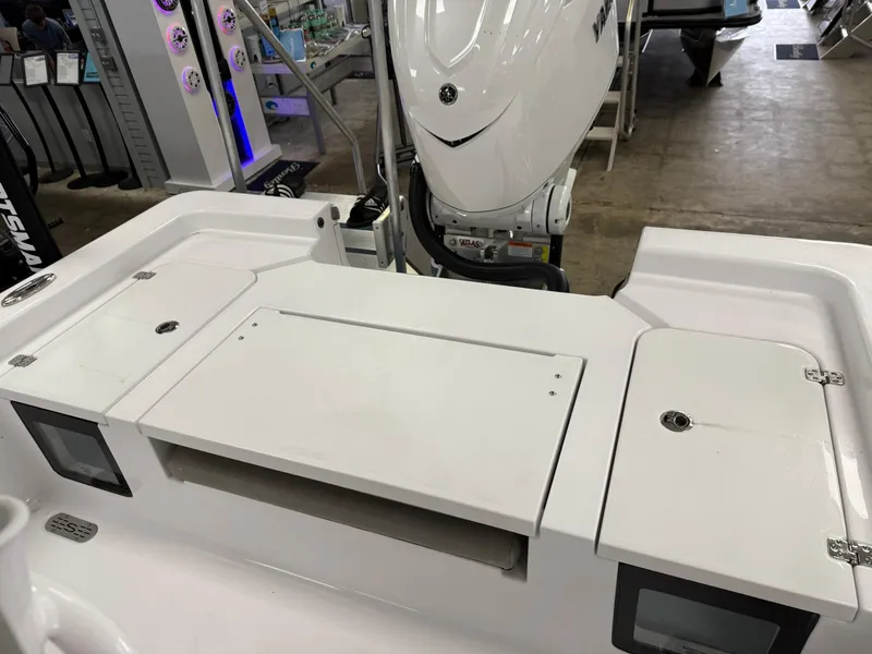 Slide: The Image of 2025 Sportsman Masters 247OE Bay Boat with outboard motor and storage compartments. - 7