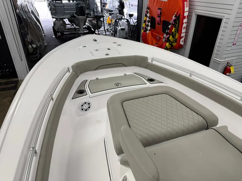 Slide: The Image of 2025 Sportsman Masters 247OE Bay Boat interior with cushioned seating and storage compartments. - 8