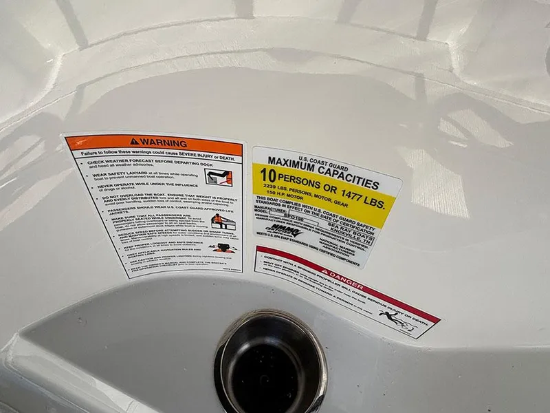 Slide: The Image of 2025 Sea Ray SPX 190 Outboard capacity warning labels, maximum 10 persons or 1477 lbs. - 11