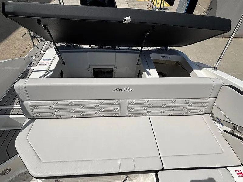 Slide: The Image of 2025 Sea Ray SPX 190 Outboard boat interior with cushioned seating and storage compartments. - 7