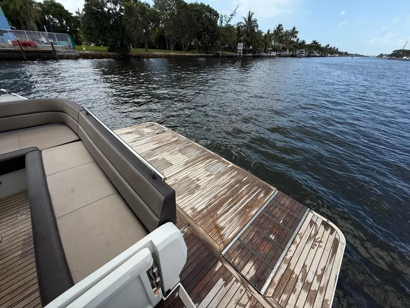 Slide: The Image of Luxury seating area on 2019 Galeon 430 HTC yacht, overlooking serene waterway. - 15