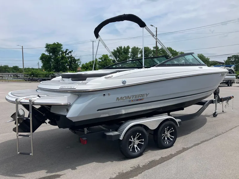 Slide: The Image of 2022 Monterey 224FS boat on trailer, parked outdoors, showcasing sleek design and modern features. - 1