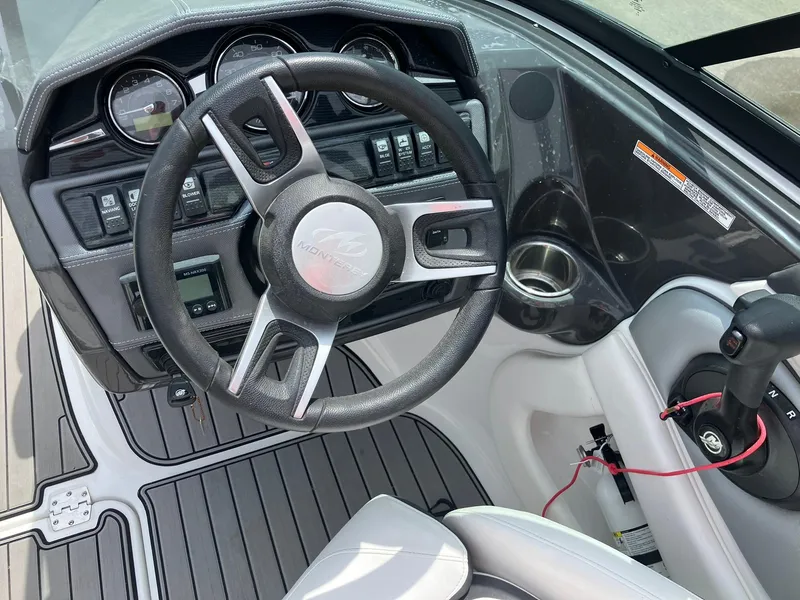 Slide: The Image of 2022 Monterey 224FS boat dashboard with steering wheel and control panel. - 10
