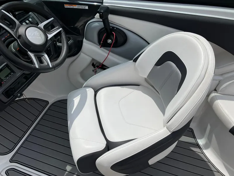 Slide: The Image of 2022 Monterey 224FS boat interior with steering wheel and white captain's seat. - 11