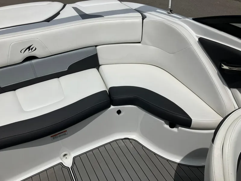 Slide: The Image of 2022 Monterey 224FS boat interior with sleek white and black seating. - 13