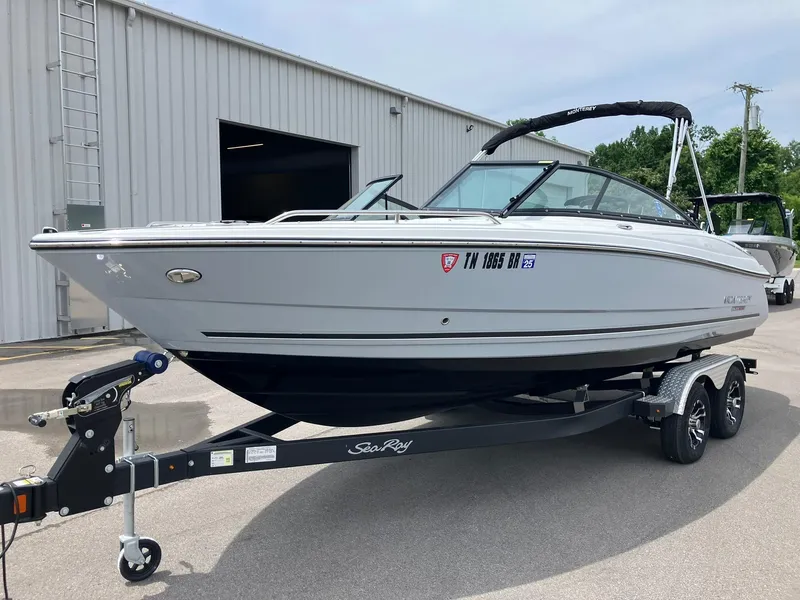 Slide: The Image of 2022 Monterey 224FS boat on trailer, parked outside a warehouse. - 4