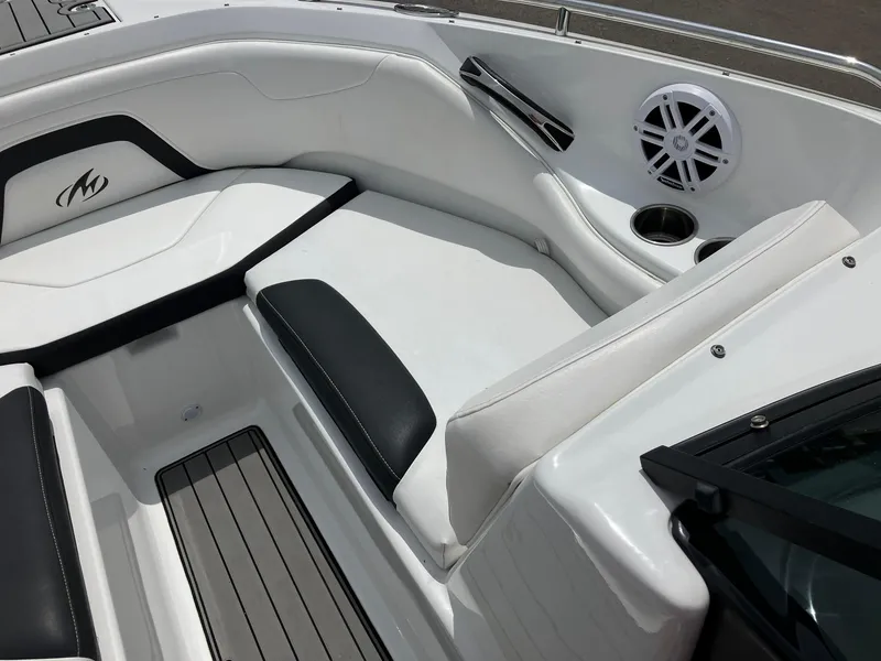 Slide: The Image of 2022 Monterey 224FS boat interior with white and black seating, speaker, and cup holder. - 7