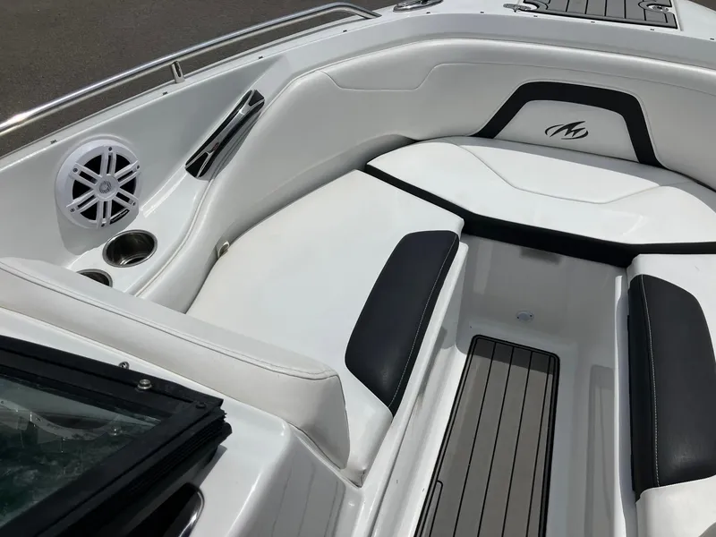 Slide: The Image of 2022 Monterey 224FS boat interior with white and black seating, speaker, and cup holder. - 8