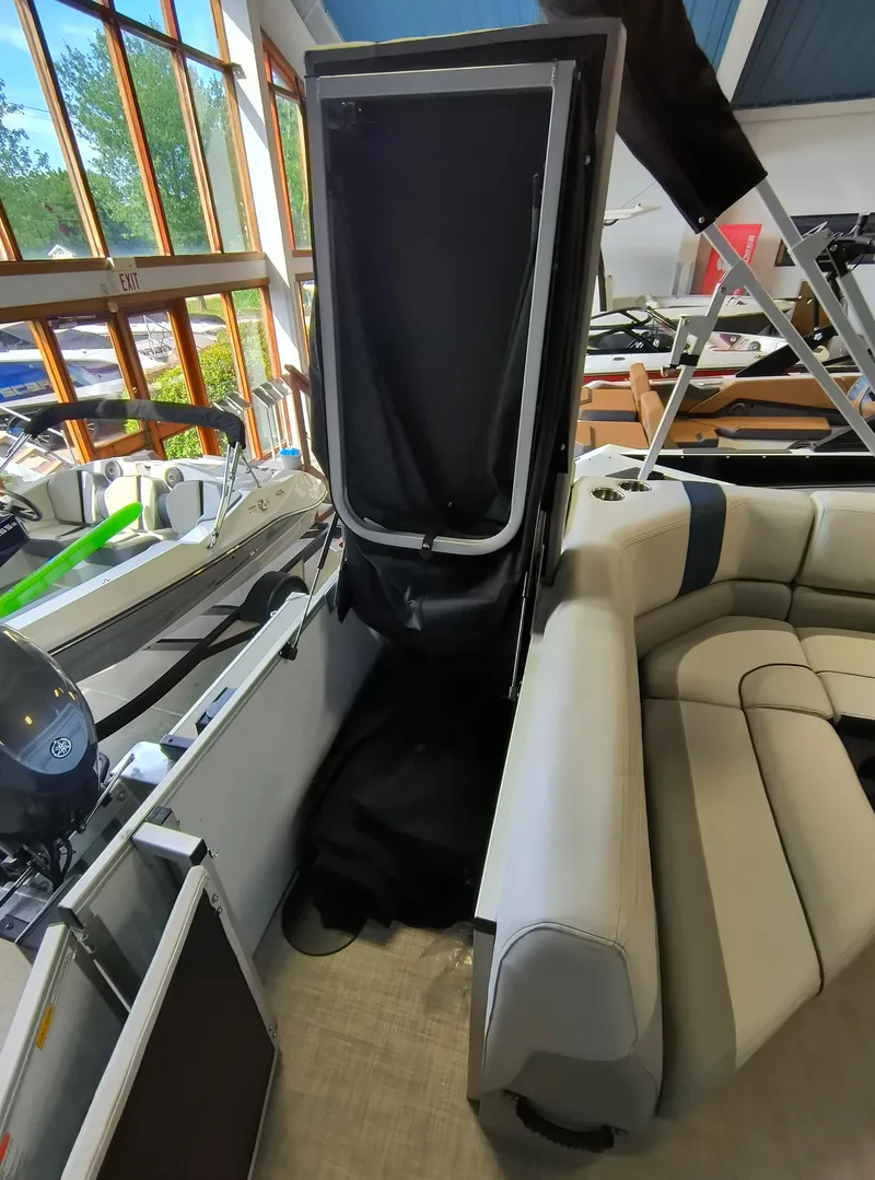 Slide: The Image of 2025 SunCatcher Select 18C pontoon boat interior with seating and storage area. - 11