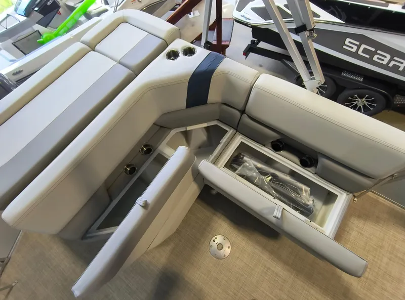 Slide: The Image of Interior of 2025 SunCatcher Select 18C boat with storage compartments and cup holders. - 6