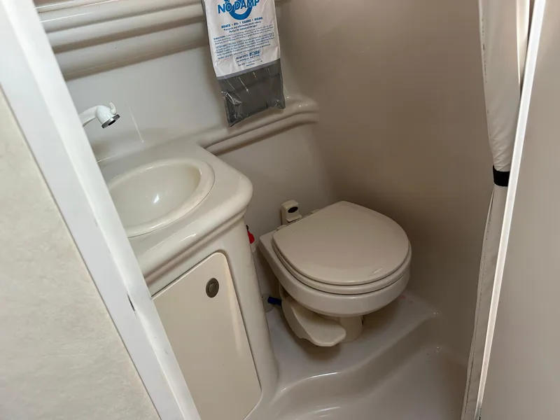 Slide: The Image of Compact bathroom in 2006 Sea Ray 260DA boat with sink and toilet. - 10