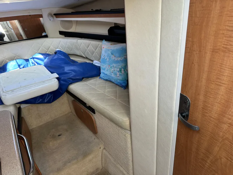 Slide: The Image of Interior cabin of a 2006 Sea Ray 260DA boat with cushioned seating. - 12