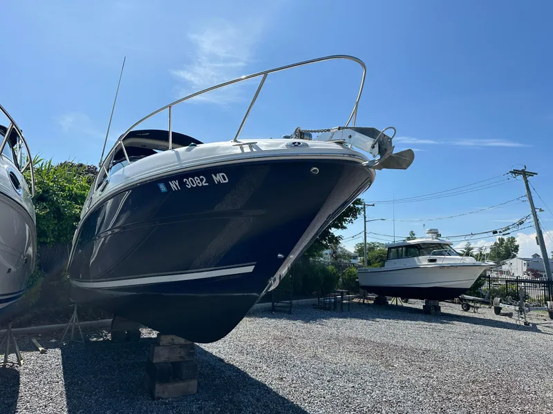 Slide: The Image of 2006 Sea Ray 260DA boat on dry dock under clear blue sky. - 3