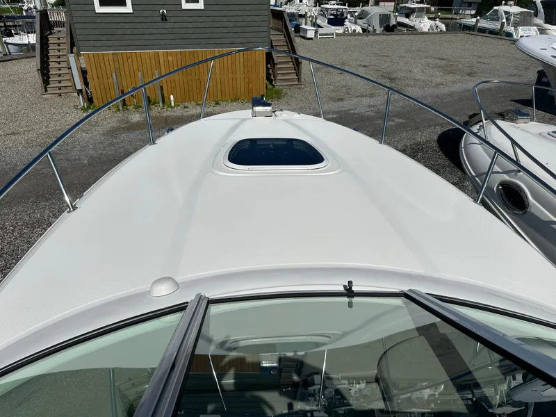 Slide: The Image of 2006 Sea Ray 260DA boat deck with hatch, docked at marina. - 5