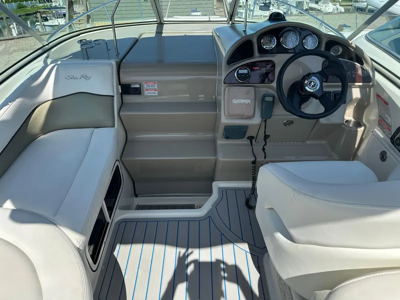 Slide: The Image of 2006 Sea Ray 260DA boat cockpit with steering wheel, gauges, and seating. - 6