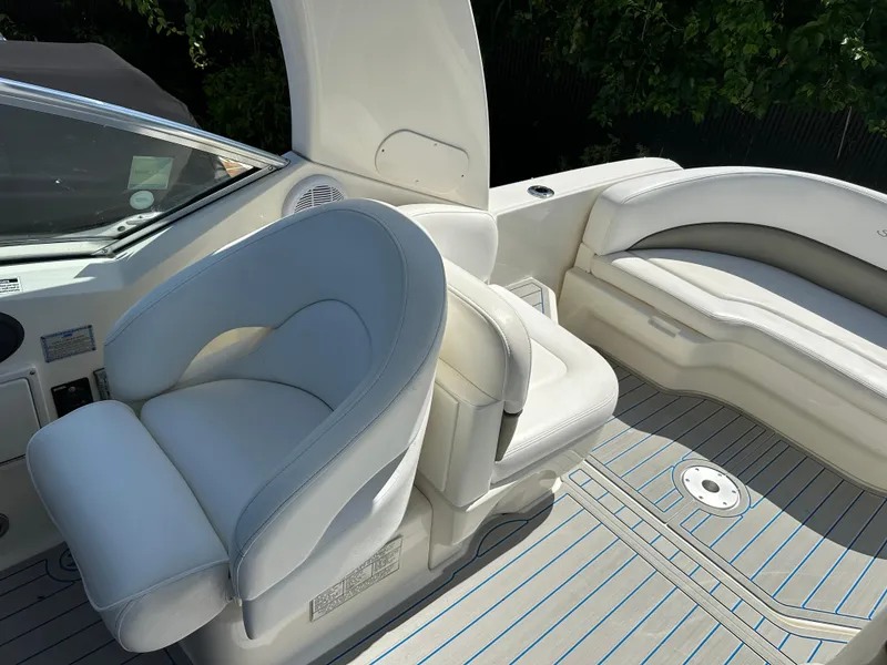 Slide: The Image of 2006 Sea Ray 260DA boat interior with white seating and sleek design. - 7