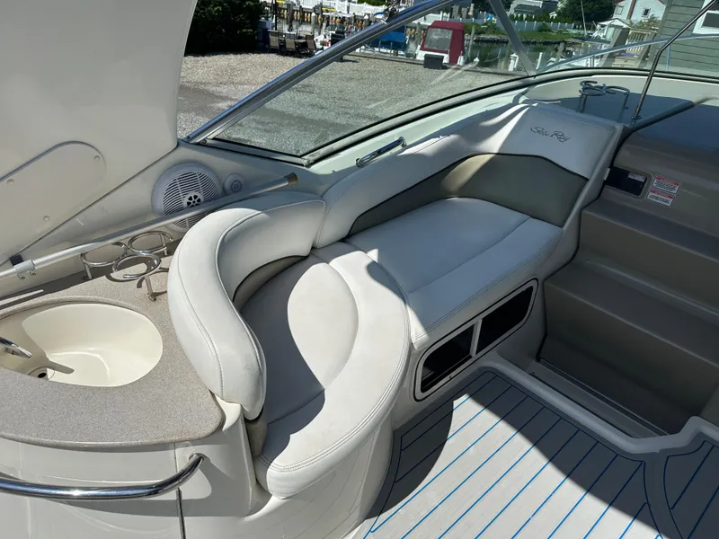 Slide: The Image of 2006 Sea Ray 260DA boat interior with cushioned seating and built-in sink. - 8