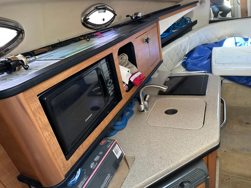 Slide: The Image of Interior of 2006 Sea Ray 260DA boat with kitchenette and storage. - 9