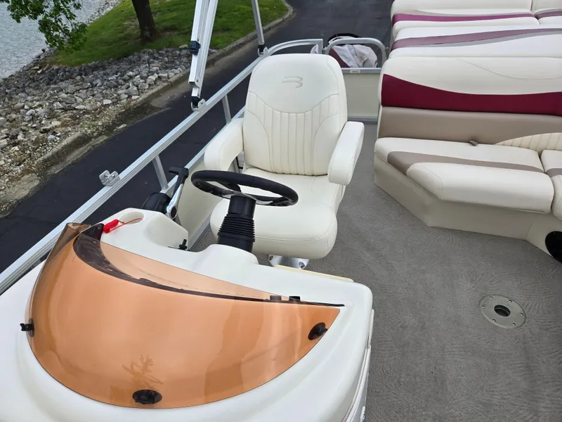 Slide: The Image of 2007 Bennington 2075GL boat interior with steering wheel and seating area. - 12