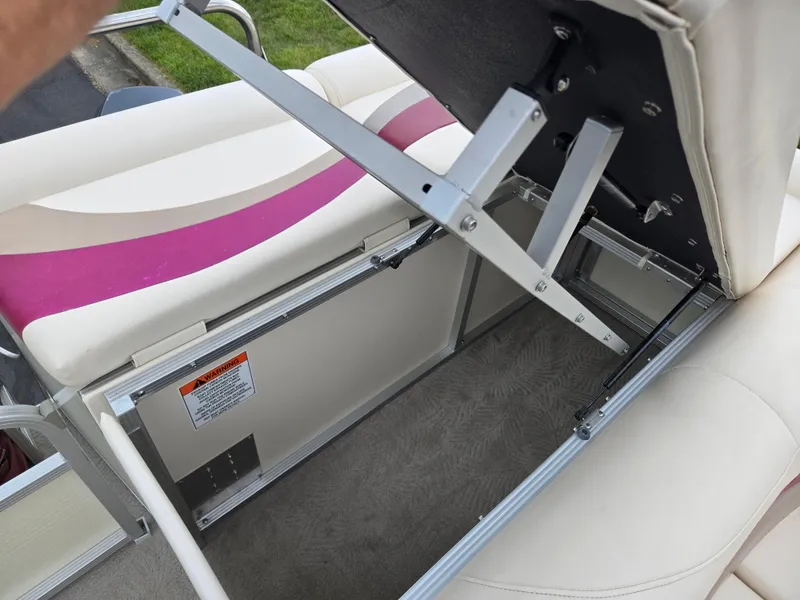 Slide: The Image of Open storage compartment in a 2007 Bennington 2075GL boat with cushioned seating. - 14